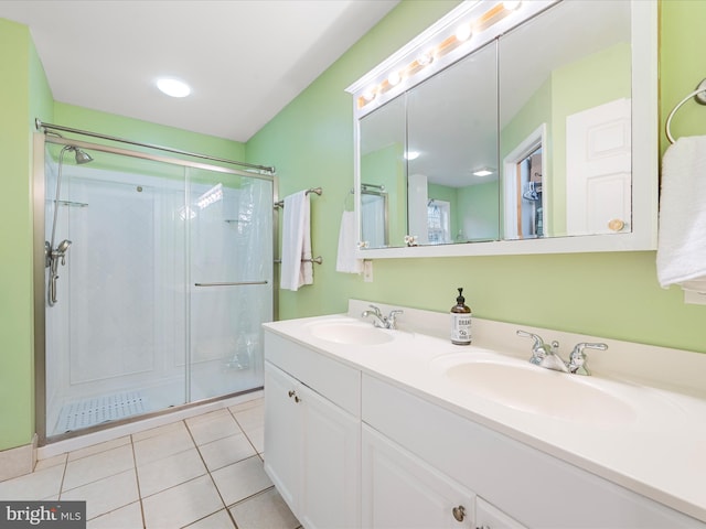 bathroom featuring tile patterned flooring, vanity, and a shower with shower door