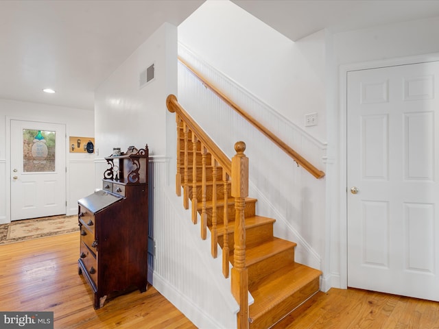 staircase with hardwood / wood-style floors