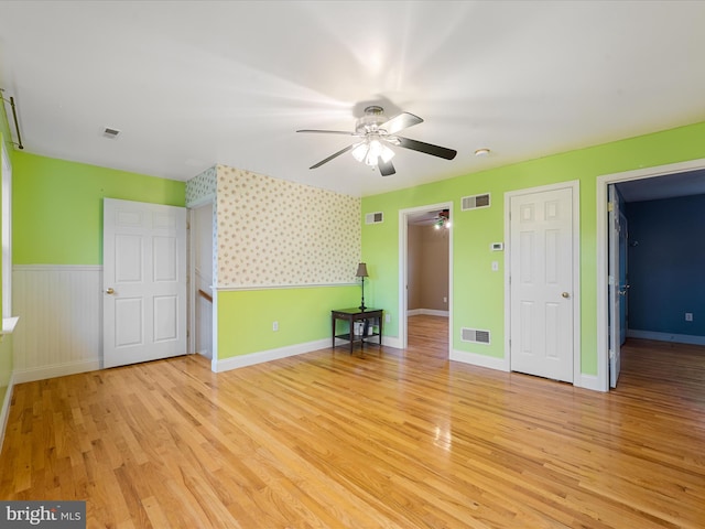 unfurnished bedroom featuring light wood-type flooring and ceiling fan