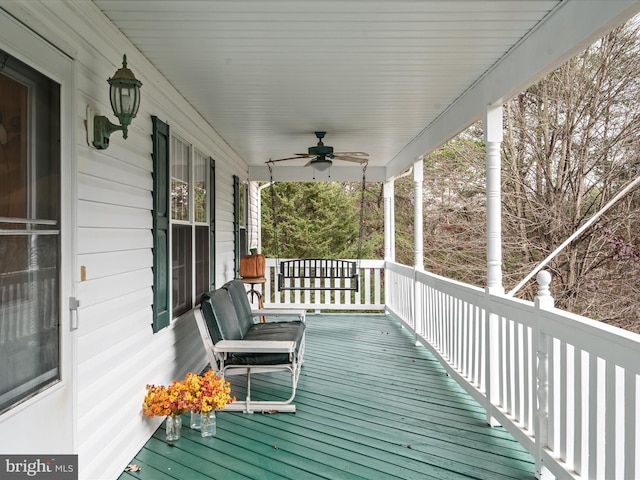 wooden terrace featuring ceiling fan