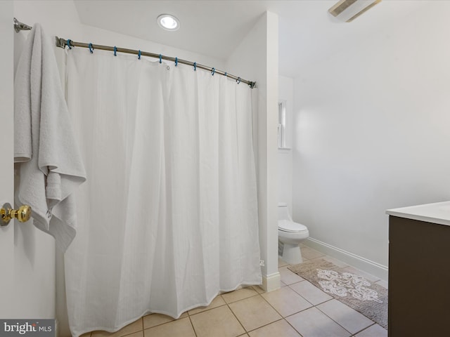 bathroom with tile patterned flooring, vanity, and toilet