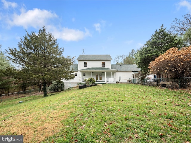 back of house featuring a yard