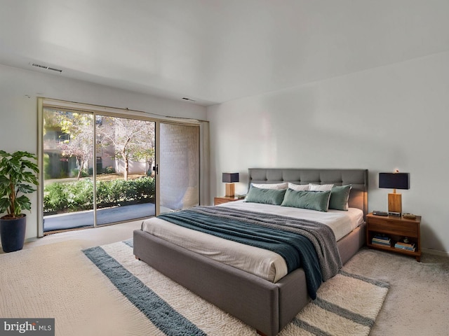 carpeted bedroom featuring access to exterior