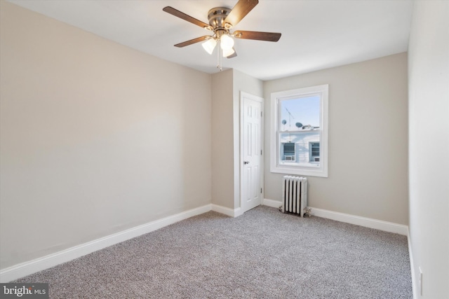 empty room featuring radiator heating unit, light colored carpet, and ceiling fan