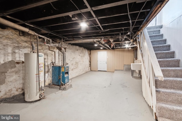 basement with a wealth of natural light, sink, and gas water heater