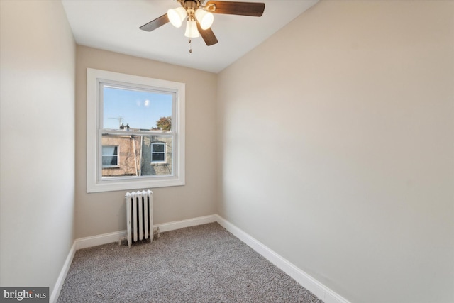 unfurnished room featuring carpet flooring, radiator heating unit, ceiling fan, and vaulted ceiling