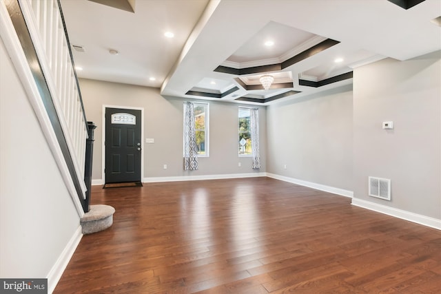 interior space with dark wood-type flooring, crown molding, and coffered ceiling