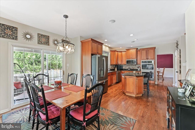 dining room featuring hardwood / wood-style floors and an inviting chandelier