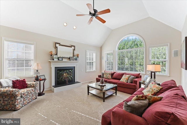 carpeted living room with high vaulted ceiling and ceiling fan