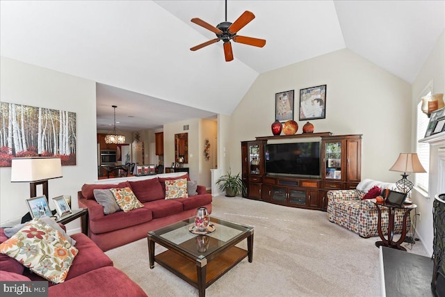 living room with light colored carpet, ceiling fan with notable chandelier, and vaulted ceiling