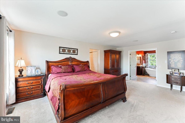 carpeted bedroom with ensuite bathroom