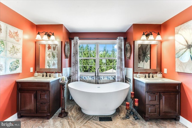 bathroom featuring vanity and a tub