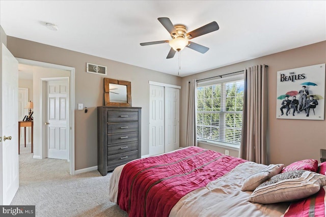 carpeted bedroom featuring ceiling fan and a closet