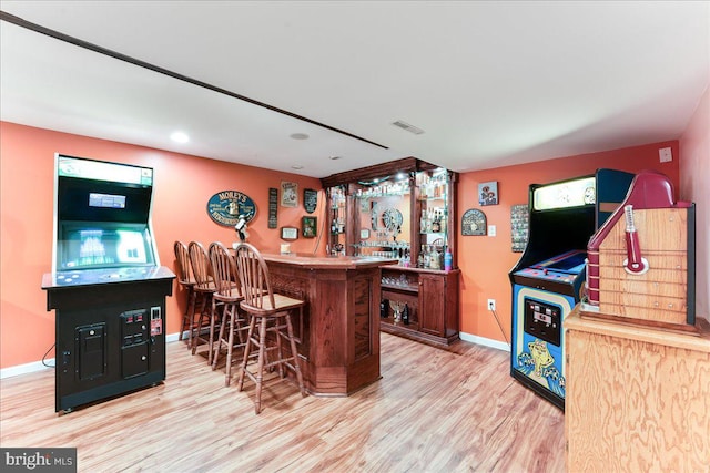 bar featuring light hardwood / wood-style floors