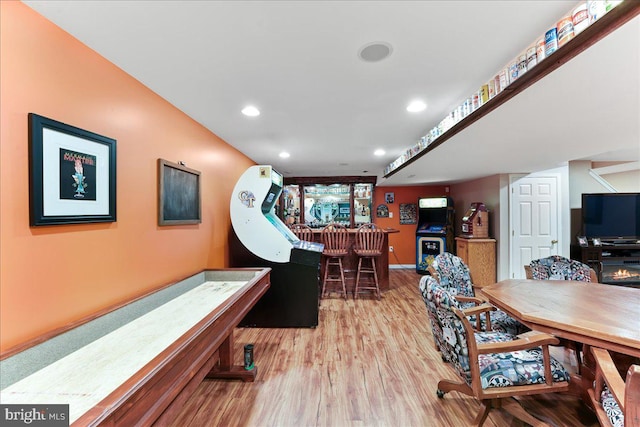 rec room featuring hardwood / wood-style flooring and bar area