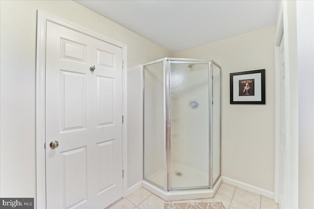 bathroom featuring walk in shower and tile patterned flooring