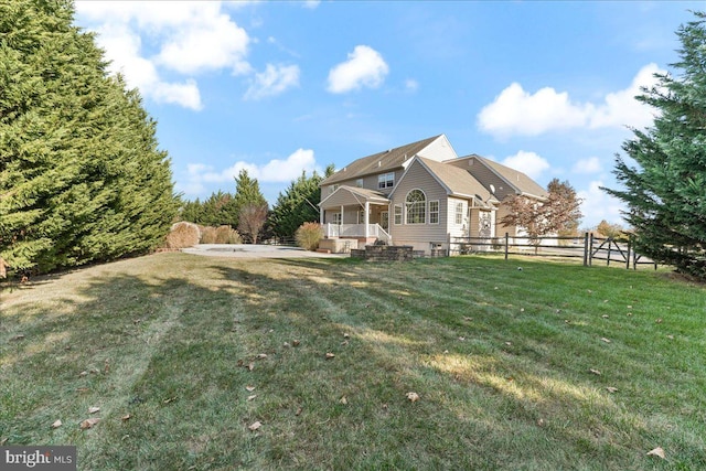 view of side of property featuring a patio area and a lawn