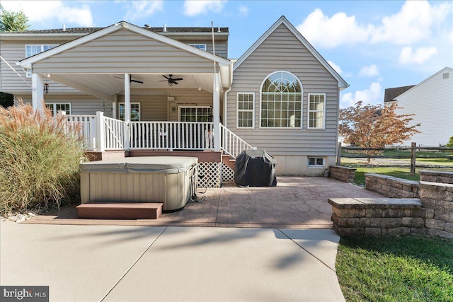 back of house featuring a hot tub, ceiling fan, and a patio area