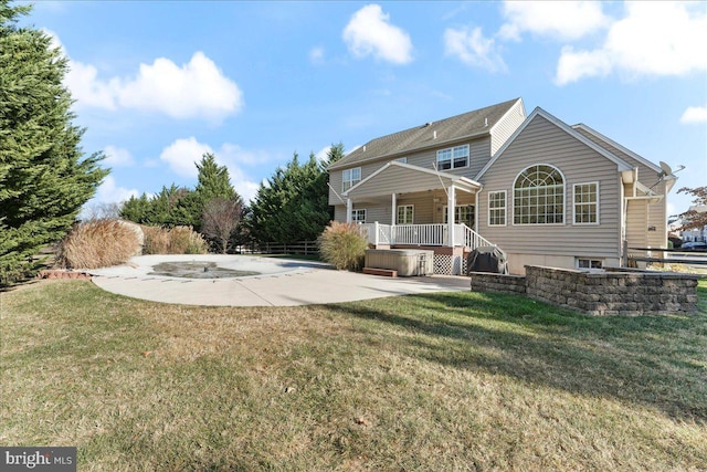 rear view of house with a lawn and a patio