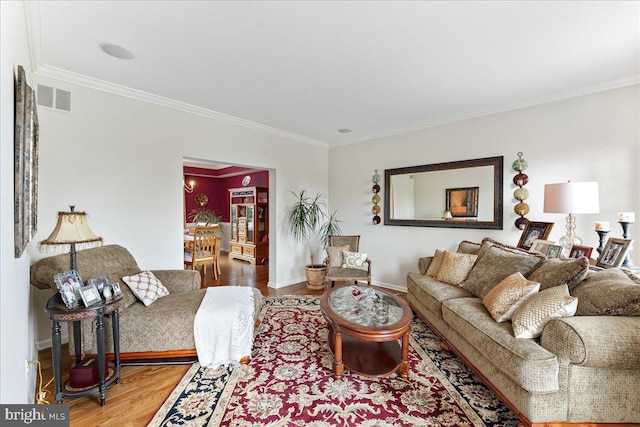 living room featuring wood-type flooring and ornamental molding