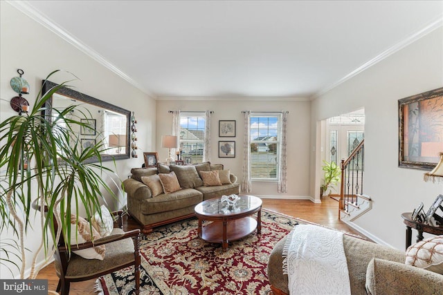 living room with light hardwood / wood-style floors and crown molding