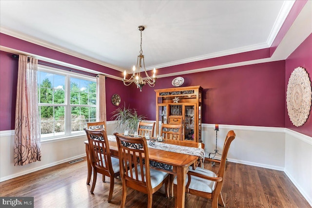 dining space with a chandelier, hardwood / wood-style flooring, and crown molding