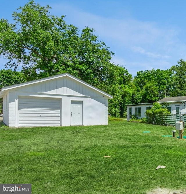 exterior space featuring a garage and a lawn