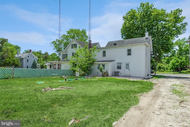 back of property with a lawn