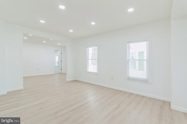 unfurnished room with light hardwood / wood-style floors and a healthy amount of sunlight