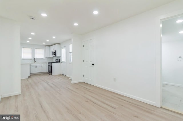 unfurnished living room featuring light wood-type flooring