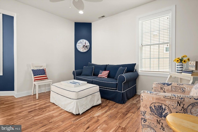 living room featuring hardwood / wood-style flooring, ceiling fan, and a healthy amount of sunlight