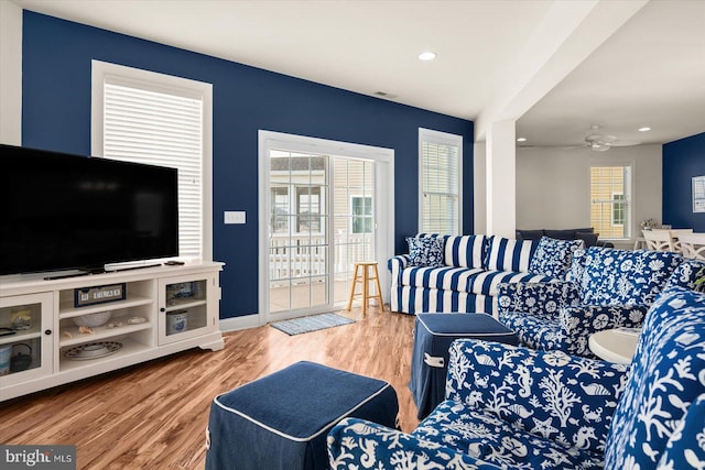 living room with hardwood / wood-style floors and ceiling fan