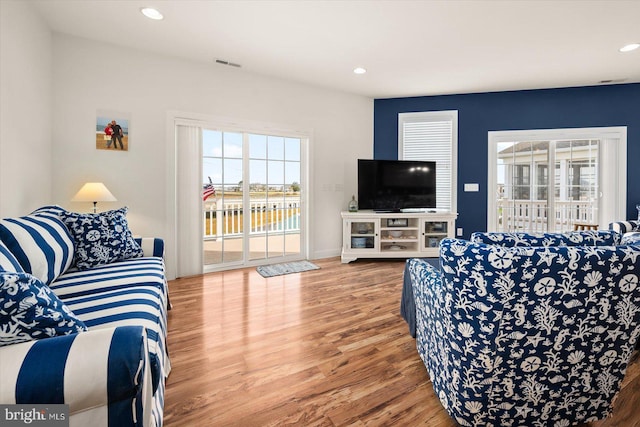 living room with plenty of natural light and hardwood / wood-style flooring