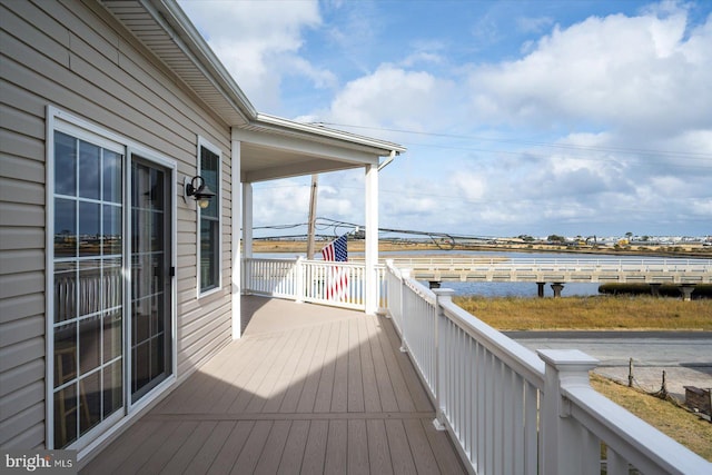 wooden deck with a water view