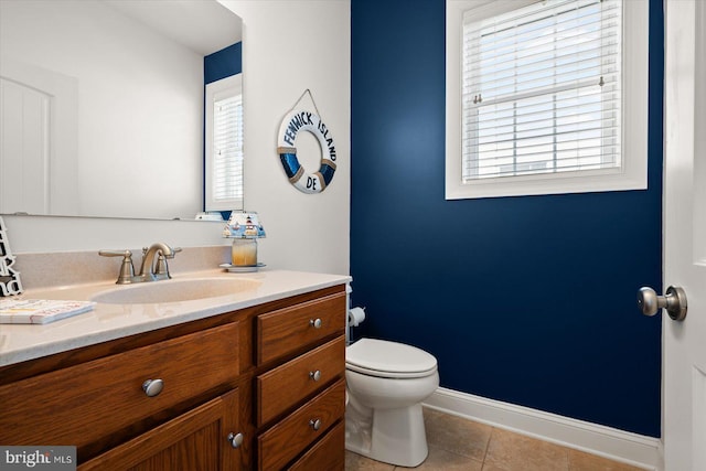 bathroom with vanity, tile patterned floors, and toilet