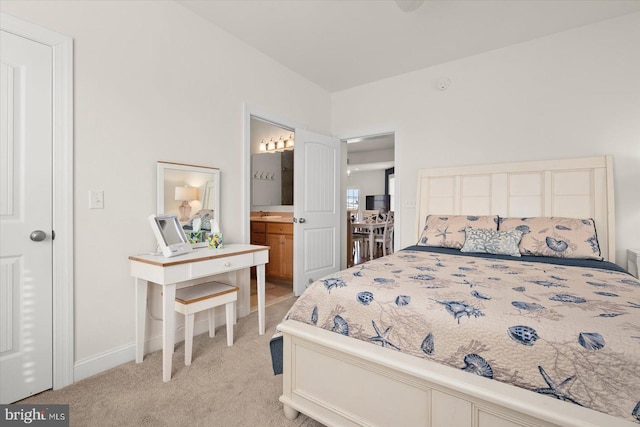 carpeted bedroom featuring ensuite bathroom