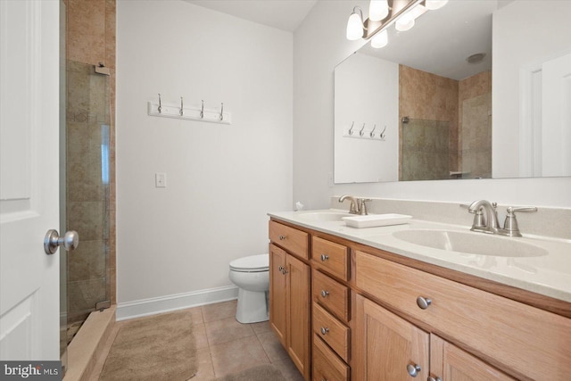 bathroom with toilet, tiled shower, tile patterned floors, and vanity