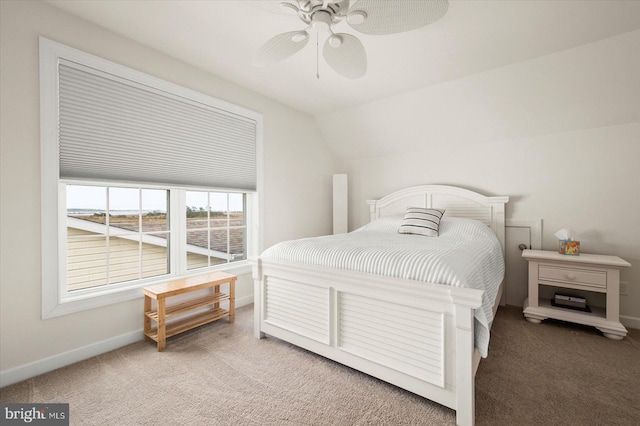 bedroom with vaulted ceiling, ceiling fan, and carpet floors