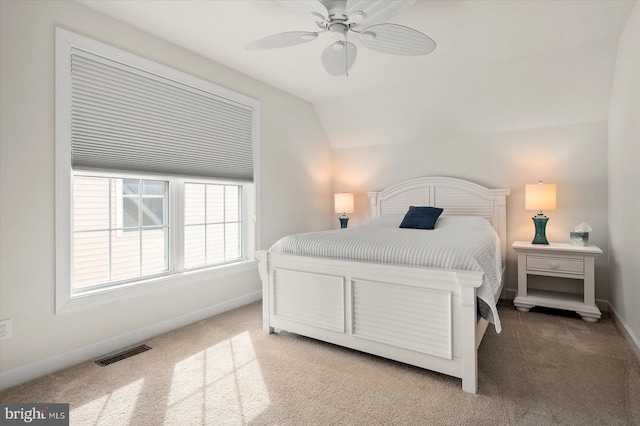 bedroom with lofted ceiling, ceiling fan, and carpet floors