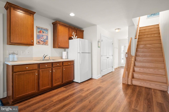 kitchen with sink, white refrigerator, and dark hardwood / wood-style flooring