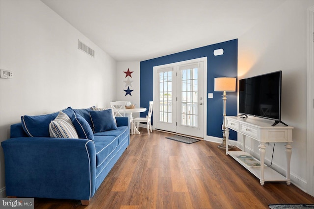 living room with dark hardwood / wood-style flooring