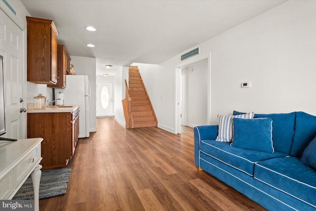 living room with dark wood-type flooring and sink