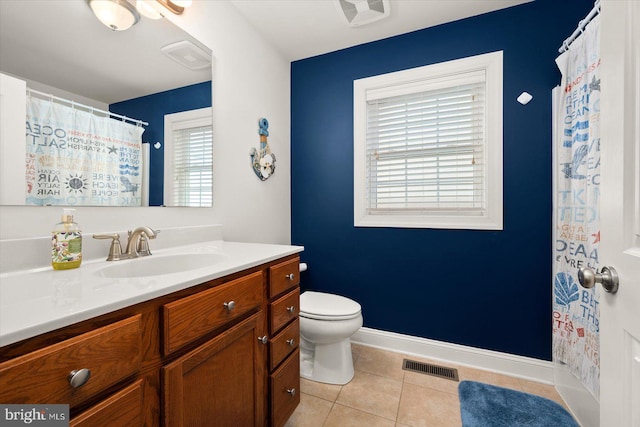 bathroom featuring vanity, tile patterned floors, and toilet