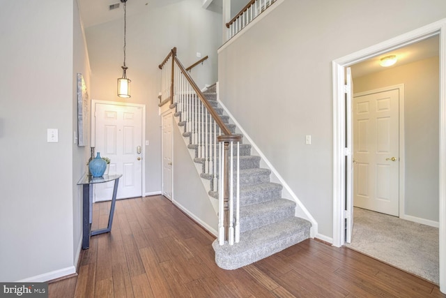 foyer featuring a high ceiling and dark hardwood / wood-style flooring