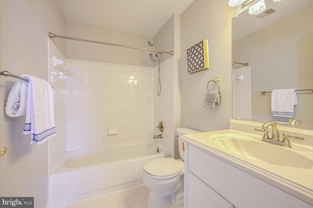 full bathroom featuring vanity, tiled shower / bath combo, and toilet