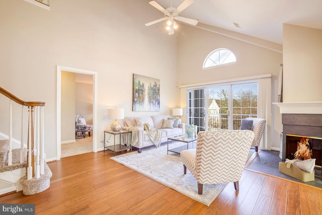 living room with high vaulted ceiling, wood-type flooring, and ceiling fan