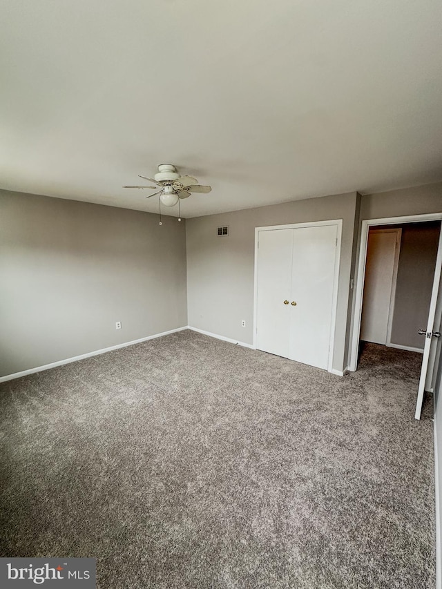 unfurnished bedroom with ceiling fan and carpet