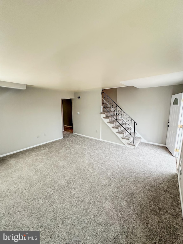 unfurnished living room featuring carpet