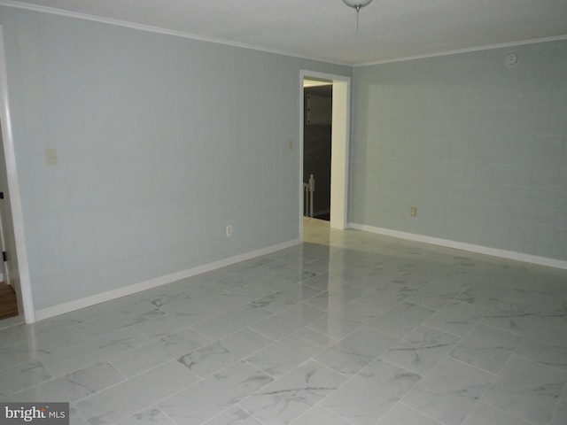 empty room featuring crown molding