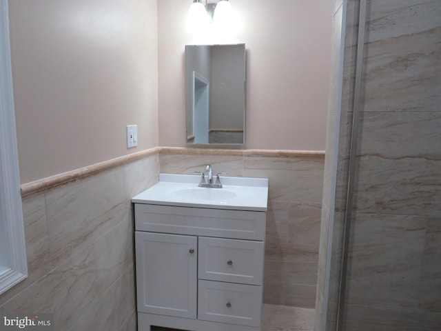 bathroom featuring vanity and tile walls